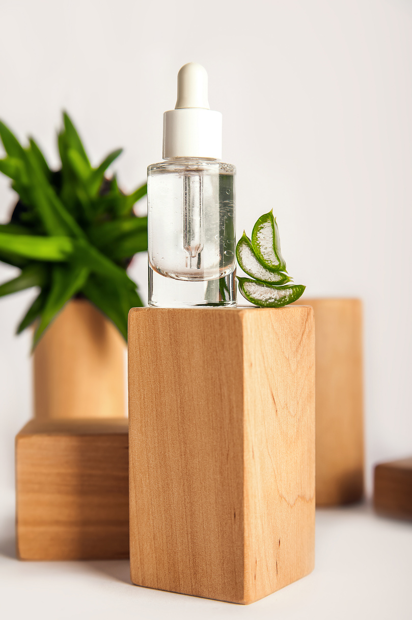 Aloe Serum with Pipette on Wooden Block Podium